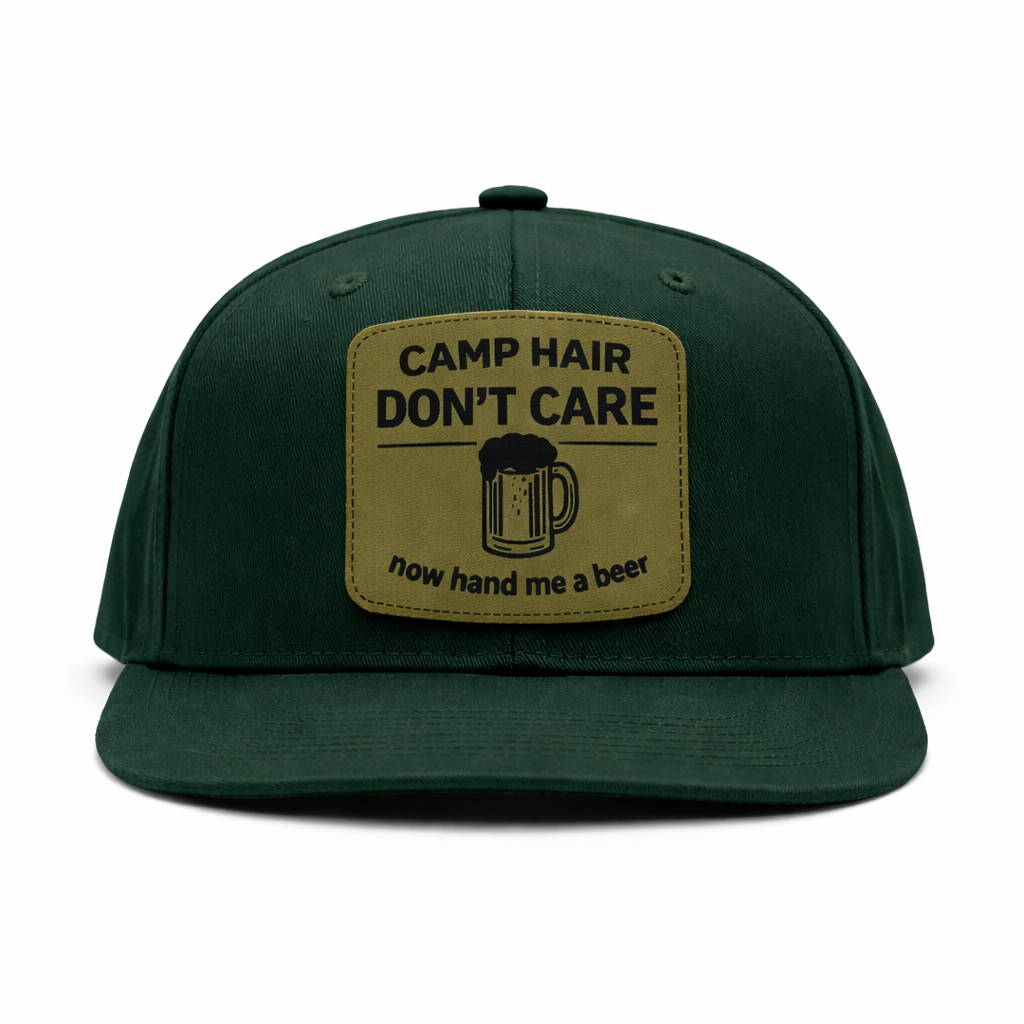 Green cap with a patch that says 'Camp Hair Don't Care, now hand me a beer' on a white background