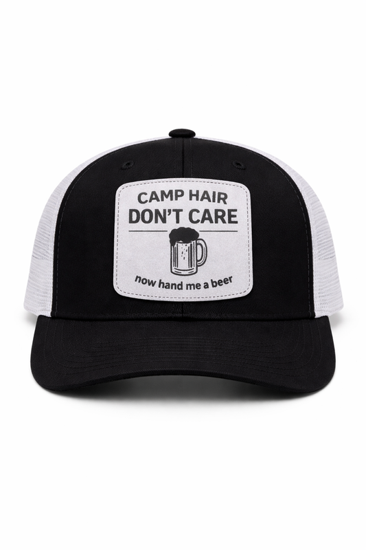 Black and white cap with text 'Camp Hair Don't Care, now hand me a beer' on a white background