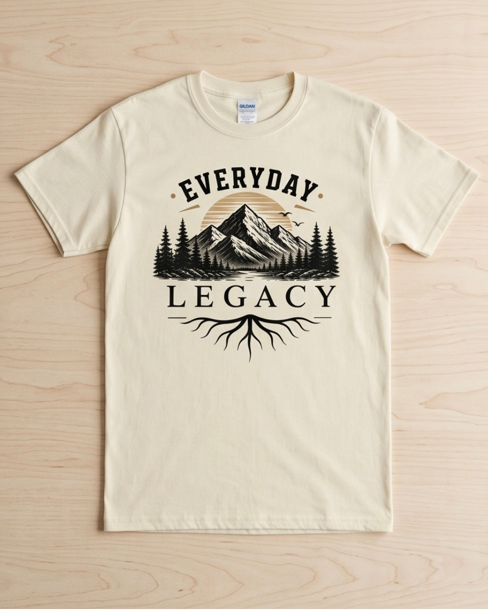 Beige t-shirt with 'Everyday Legacy' graphic design on a wooden surface