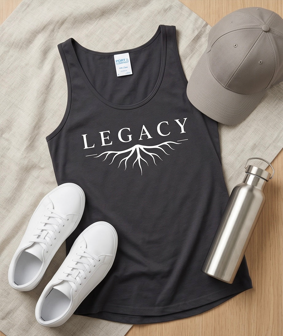 Black tank top with 'LEGACY' design, white sneakers, gray cap, and silver water bottle on a wooden surface.