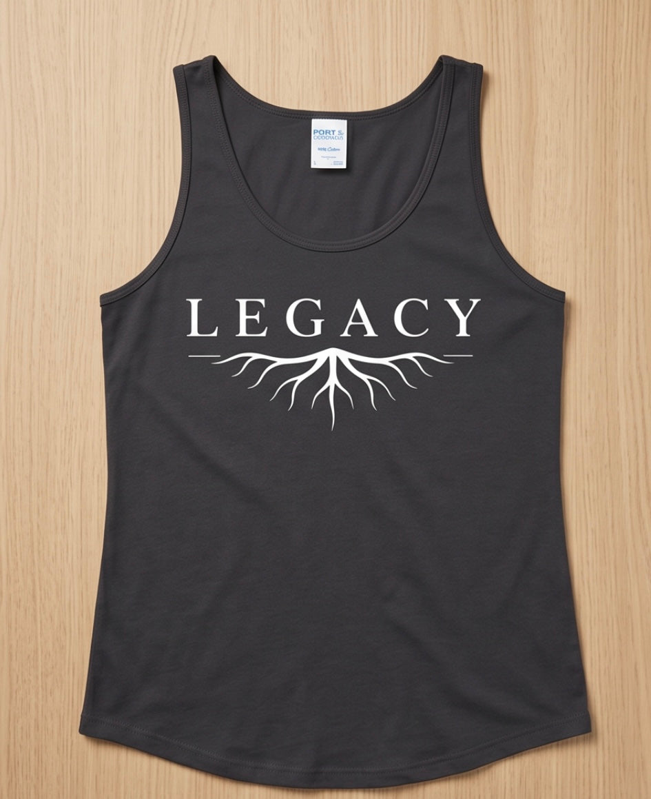 Black tank top with 'LEGACY' and root design on a wooden surface