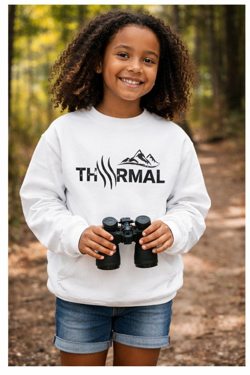 THRMAL logo, holding binoculars in a forest setting